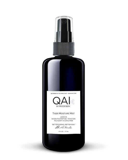 Black spray bottle with QAI label on a white background